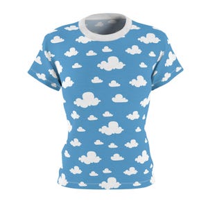 May include: A light blue t-shirt with a white cloud pattern.