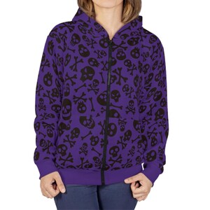 May include: A purple zip-up hoodie with a black skull and crossbones pattern.