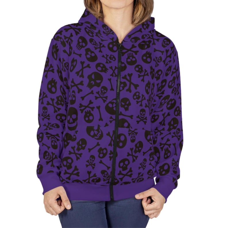 May include: A purple zip-up hoodie with a black skull and crossbones pattern.