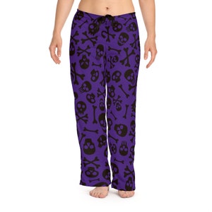 May include: Purple pyjama trousers with a black skull and crossbones pattern.