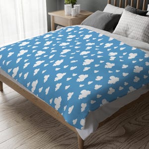 May include: A blue fleece throw blanket with a white cloud pattern.