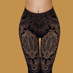 May include: Black leggings with a geometric pattern in gold. The pattern is intricate and detailed, and it covers the entire leggings.