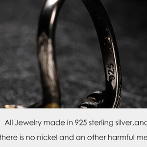 May include: Close-up of a silver ring with the inscription "925" on the inside band. The ring is made of 925 sterling silver and is nickel-free.