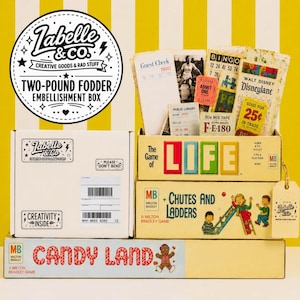 May include: A two-pound fodder embellishment box from Labelle & Co. containing vintage-style paper ephemera, including guest checks, bingo cards, and tickets, alongside board game boxes for The Game of Life, Chutes and Ladders, and Candy Land.
