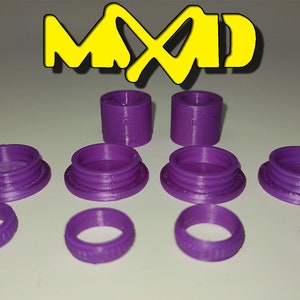 May include: A set of purple 3D printed plastic rings and caps. The rings are different sizes and have a textured surface. The caps are also different sizes and have a smooth surface.