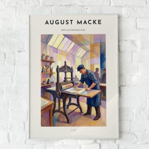 May include: A framed art print titled AUGUST MACKE DER KUPFERDRUCKER featuring a painting of a person in a blue apron operating a large black printing press. The scene includes shelves with jars and brushes, rendered in a colourful, geometric style.