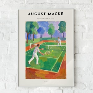 May include: A framed art print featuring the painting Tennisspieler im Park by August Macke. The artwork depicts two figures in white clothing playing tennis on a green court surrounded by trees, with the text August Macke and Tennisspieler im Park.