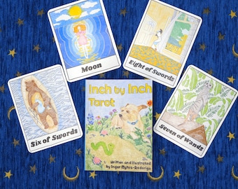 May include: A set of tarot cards with illustrations of animals and people. The cards are white with colorful illustrations and black text. The cards are laid out on a blue background with gold stars. The text on the cards reads "Moon", "Eight of Swords", "Seven of Wands", "Six of Swords", and "Inch by Inch Tarot".