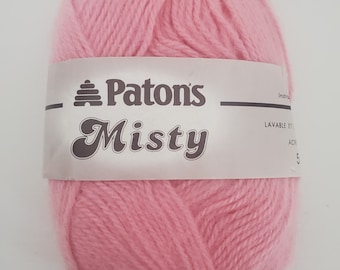 May include: A ball of pink Patons Misty yarn. The label reads "Patons Misty" with a beehive logo.