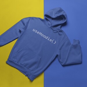 May include: A blue hoodie with the text "useHoodie()" in white on the front.