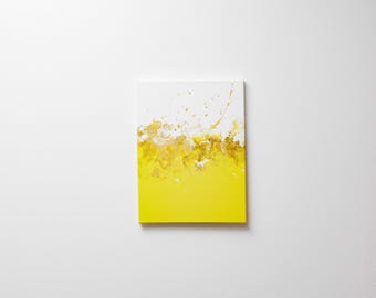 May include: Abstract painting on canvas with a white background and yellow paint splattered across the bottom half of the canvas.