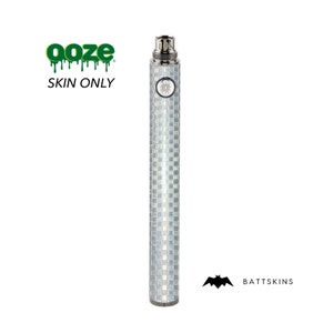 May include: A silver and white checkered vape skin with the text "ooze" and "SKIN ONLY" in green. The skin is designed for a vape mod with a 510 thread connection. The skin is made by Battskins.