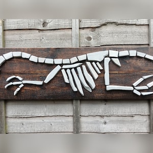 Raptor dinosaur fossil wall art made from reclaimed wood