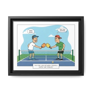 May include: A framed cartoon print depicting a pickleball match. Two players shake hands over the net, one saying "Good Game," the other, "Yeah, Yeah, Whatever." The text at the bottom reads, "The fine line between 'friendly match' and 'rivalry.'"