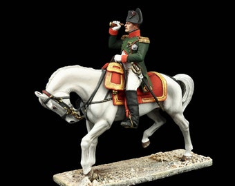 May include: A painted figurine of a military officer on horseback. The officer is wearing a green uniform with red trim and a black hat. He is holding a telescope in his right hand and is looking to the right. The horse is white and is in a rearing position. The figurine is on a brown base.