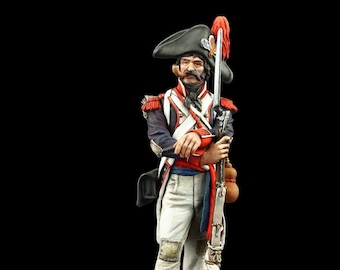 May include: A hand-painted miniature figurine of a French soldier from the Napoleonic era. The soldier is wearing a white uniform with red and blue accents, a black hat with a red plume, and a white sash. He is holding a musket and has a bandolier across his chest.