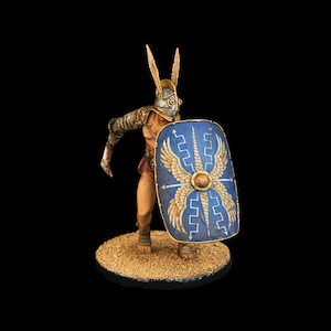 May include: A painted miniature figurine of a Roman gladiator wearing a helmet with a feathered crest and holding a shield with a blue and gold design.
