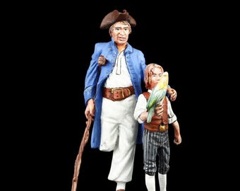 May include: A detailed figurine depicting a pirate and a young boy with a parrot. The pirate wears a blue coat, white pants, and a brown hat, holding a wooden cane. The boy has a vest, striped pants, and holds a parrot.