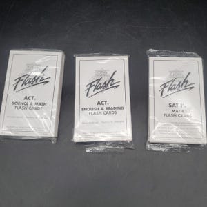 May include: Three sets of white rectangular flash cards in clear plastic packaging. The first set is labeled ACT Science & Math, the second is ACT English & Reading, and the third is SAT I Math. Each card set features the In-A-Flash logo at the top.