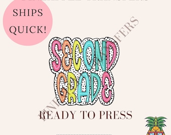 May include: A colorful iron-on transfer design featuring the words "Second Grade" in a bold, playful font with black polka dots. The design is ready to press and is a cold peel DTF transfer.