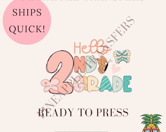 May include: A ready-to-press iron-on transfer design featuring the text "Hello 2nd Grade" in colorful letters with butterflies and hearts. The design is on a white background.