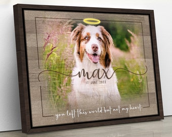 May include: A framed canvas print featuring a photograph of a dog with a halo above its head. The dog is looking at the camera with its tongue out. The text "max" is written in cursive below the dog's photo, along with the date "17 June 2022". The text "you left this world but not my heart." is written below the date.
