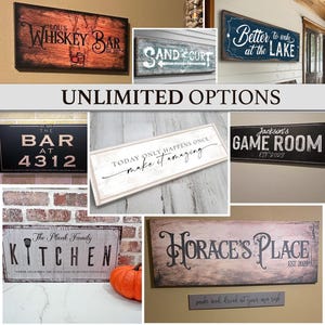 May include: Collection of rustic wooden signs with various phrases, including "Whiskey Bar," "Sand & Surf," and "Better to wake at the Lake." Other signs say "The Bar at 4312," "Today only happens once make it amazing," "Jackson's Game Room," "The Plank Family Kitchen," and "Horace's Place."