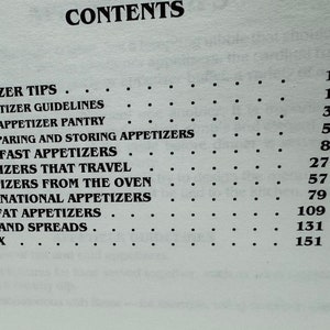 May include: A black and white page with the word "CONTENTS" at the top. The page lists appetizer recipes with page numbers for each section. The sections include "Appetizer Tips", "Appetizer Guidelines", "The Appetizer Pantry", "Preparing and Storing Appetizers", "Superfast Appetizers", "Appetizers That Travel", "Appetizers From The Oven", "International Appetizers", "Low Fat Appetizers", "Dips and Spreads", and "Index".