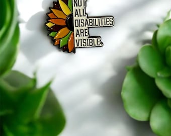 May include: A sunflower-shaped enamel pin with the text "NOT ALL DISABILITIES ARE VISIBLE."