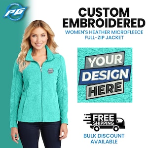 May include: A turquoise blue fleece jacket with a zipper closure. The jacket has a small embroidered logo on the left chest that says "Your Design". The image also shows a mock-up of a custom embroidered design on a turquoise blue fleece jacket.