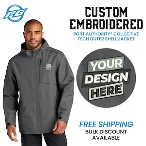 May include: A gray tech outer shell jacket with a zipper closure and a hood. The jacket has a patch on the left chest that says "YOUR DESIGN HERE". The text "CUSTOM EMBROIDERED" and "PORT AUTHORITY COLLECTIVE" is displayed above the jacket. The text "FREE SHIPPING" and "BULK DISCOUNT AVAILABLE" is displayed below the jacket.