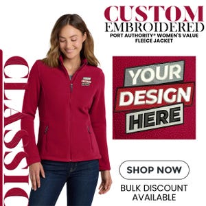 May include: A red fleece jacket with a zipper closure and two front pockets. The jacket has the text "YOUR DESIGN HERE" embroidered on the chest. The image also includes the text "CUSTOM EMBROIDERED" and "PORT AUTHORITY WOMEN'S VALUE FLEECE JACKET".