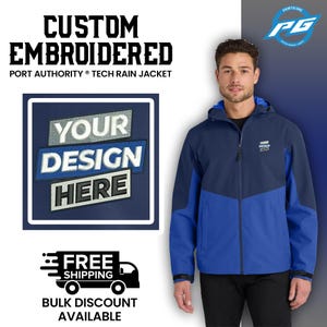 May include: A blue and navy blue tech rain jacket with a zipper closure and a hood. The jacket has a patch on the left chest that says "Your Design Here".