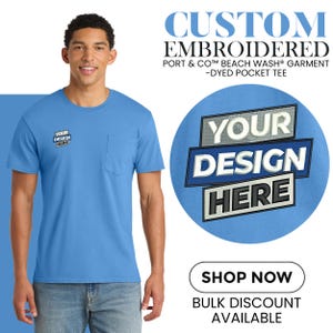 May include: A light blue pocket tee with the text "YOUR DESIGN HERE" embroidered on the pocket and chest. The image also displays the text "CUSTOM EMBROIDERED" and "SHOP NOW".