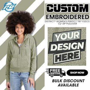 May include: A green fleece pullover with a half-zip closure. The pullover has a hood and a small embroidered logo on the left chest. The text "CUSTOM EMBROIDERED DISTRICT® WOMEN'S PERFECT TRI® FLEECE 1/2-ZIP PULLOVER YOUR DESIGN HERE FREE SHIPPING SHOP NOW BULK DISCOUNT AVAILABLE" is visible on the image.