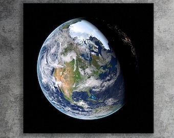 May include: A photograph of Earth from space, showing North America and parts of South America. The planet is illuminated by the sun, with a dark shadow cast across the Pacific Ocean.