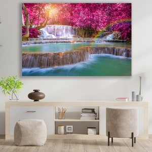 May include: A vibrant landscape painting featuring a cascading waterfall surrounded by lush greenery and pink trees. The water is clear and turquoise, and the trees are in full bloom.