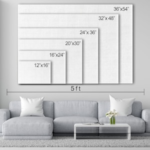 May include: A white canvas print mockup showing different sizes available. The canvas print is displayed on a wall above a gray couch with a coffee table and a plant. The sizes are 12"x16", 16"x24", 20"x30", 24"x36", 32"x48", and 36"x54".