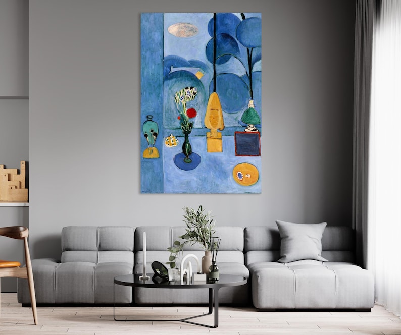 May include: A vertical abstract painting in shades of blue. It depicts a table with a vase of flowers, a lamp, and other decorative objects. The artwork has a modern, minimalist style.