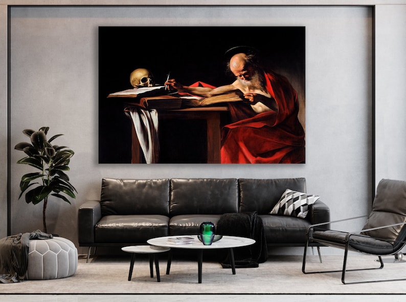 May include: A painting of a man in a red robe writing on a book with a skull on the table beside him. The painting is set against a dark background.