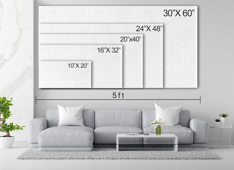 May include: A white canvas with different sizes marked out, showing the dimensions in inches. The canvas is displayed on a wall above a gray couch and a coffee table. The text "5 ft" is written below the canvas.
