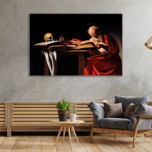 May include: A painting of a man in a red robe sitting at a table with a skull and a quill pen. The man is writing in a book. The painting is dark and moody, with a strong sense of drama.