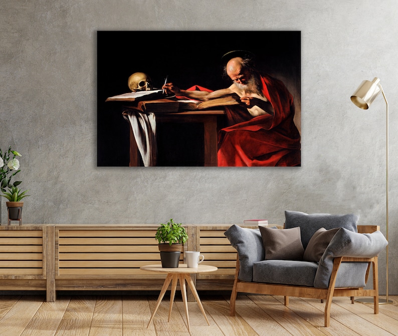 May include: A painting of a man in a red robe sitting at a table with a skull and a quill pen. The man is writing in a book. The painting is dark and moody, with a strong sense of drama.