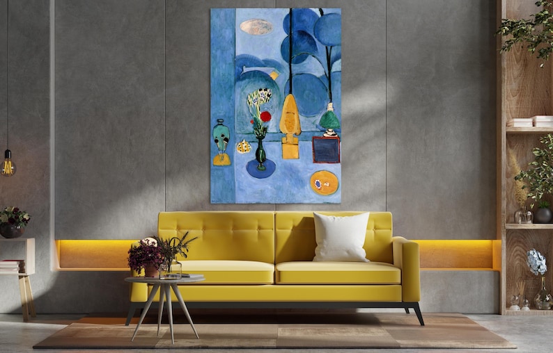 May include: An abstract painting in shades of blue, yellow, and white hangs above a yellow sofa with a white pillow. The painting features stylized shapes, including a vase of flowers and a red sphere. The room has a modern design.