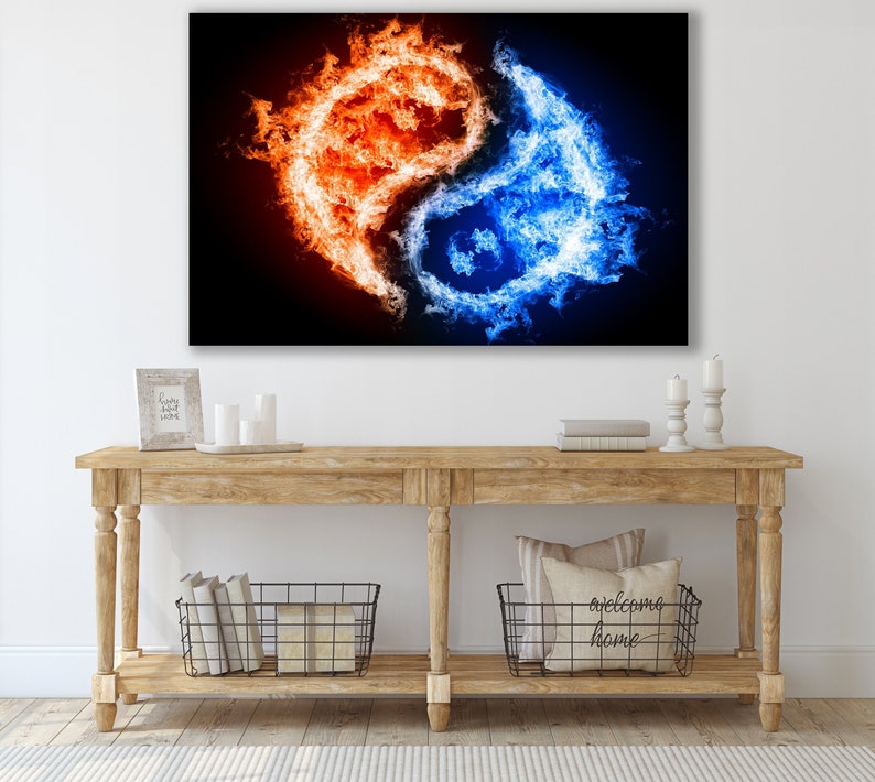 May include: Abstract art print featuring a yin yang symbol made of fire and water. The left side of the symbol is orange and red flames, while the right side is blue and white water. The background is black.