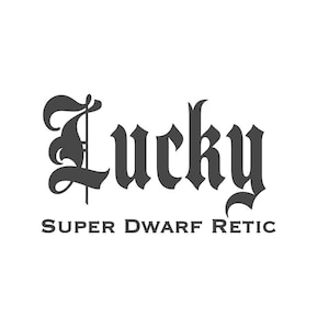 May include: A black and white logo with the word "Lucky" in a gothic font, with the text "Super Dwarf Retic" below it. The design is centered on a white background.