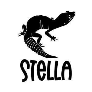 May include: A black silhouette of a gecko with a curled tail, set against a white background. The gecko is in a dynamic pose, with the word "STELLA" in bold, black letters below it. This design is suitable for stickers, apparel, or home decor.