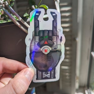 May include: A holographic sticker of a robot hand giving the rock and roll hand gesture. The robot hand is black and grey with a red light on the palm. The sticker has the text "EXIT CARD" on the bottom.