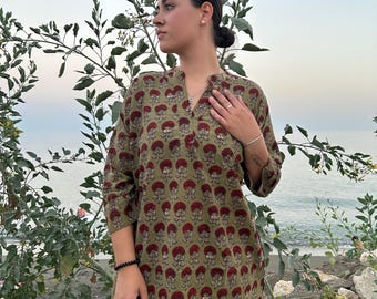 May include: A green and red floral print short-sleeved dress with a V-neckline.