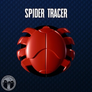 May include: A red Spider Tracer prop with a segmented design, resembling a spider. The prop is set against a dark blue background with a repeating pattern. The text "SPIDER TRACER" is displayed above the prop in white. A logo is in the lower left corner.